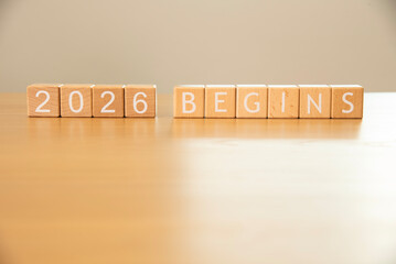 Wooden cube blocks 2026 begins background. Texts and numbers on wooden blocks with copy space. 2026 happy new year idea concept.