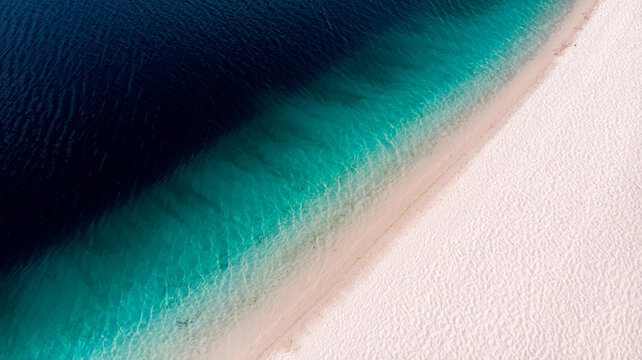 Aerial view of the dazzling contrast between the deep indigo waters and the pristine white sands of Lake McKenzie, Fraser Island, Queensland, Australia.