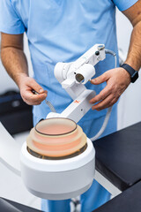 Technician handling diagnostic imaging arm. Medical professional adjusting equipment for accurate positioning