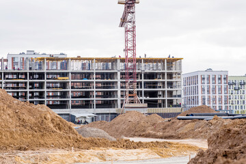 Fototapeta premium Construction of new residential areas. Construction tower crane on a sunny day. New buildings. Vidnoye, Leninsky District, Moscow Region.