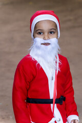 playful christmas moment with smiling child in santa outfit