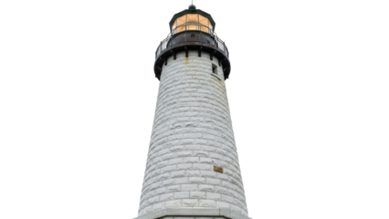 Isolated stone lighthouse, illuminated lantern room atop a tower, no people, scenic lookout