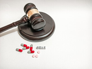 A judge’s gavel beside scattered pills and the word “HELP” reflects the intersection of law, healthcare, accountability, and urgent pleas within medical and legal systems.