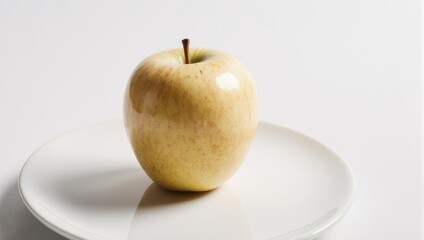 Golden Delicious Apple on White Plate with Minimalist Background.