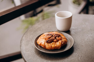 Fresh apple pastry served with black coffee on wooden tray in cafe.