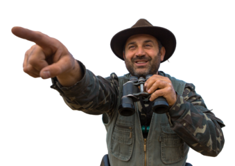 Hunter man in camouflage with a gun during the hunt in search of wild birds or game.