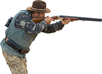 Mature hunter man holding a shotgun and walking through a field