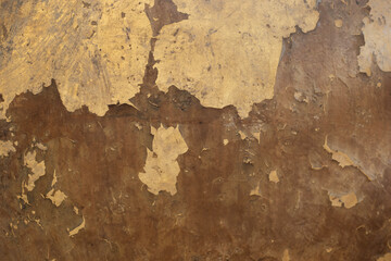 The old wall surface is rough and has abstract vintage golden cracks.