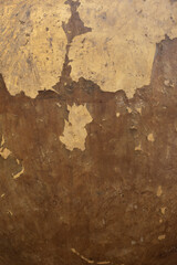 The old wall surface is rough and has abstract vintage golden cracks.