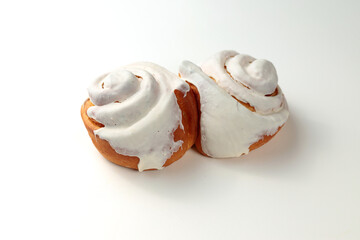 Fragrant Cinnabons with cream on a white background. Insulation