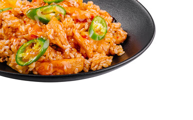 Spicy chicken and rice dish being served on black plate