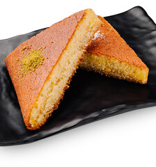 Traditional dessert served on a black plate at a cultural event