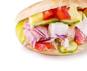 Delicious fresh sandwich with colorful vegetables and sauce on a soft bread