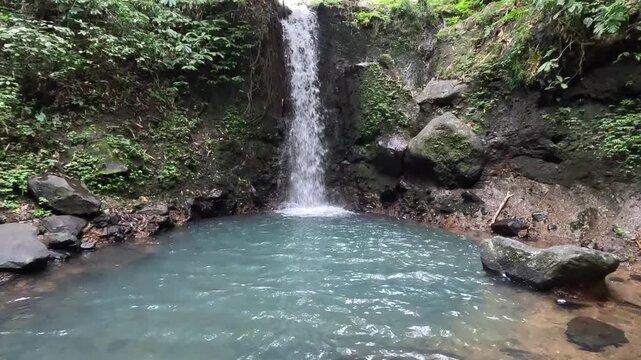 beautiful waterfall, known as Tibu Sampi Waterfalls amidst fascinating vegetation, is located in Selemadeg Timur, Tabanan, Bali, Indonesia