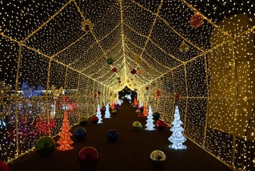 Magical Christmas Light Tunnel with Shimmering Decorations and Glowing Trees.