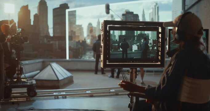 Director and Crew Film a Rooftop Dialogue on a Tracking Dolly, Monitoring Actors Through On-set Screens While a Large Led Wall Projects a Virtual City, Successful Dramatic Action Take.