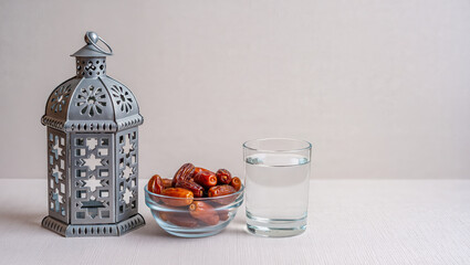 Beautiful evening with lantern, glass of water, and sweet dates, creating a serene atmosphere