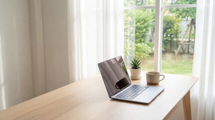 Fototapeta premium Bright Home Office Desk with Laptop, Coffee, and Green Plant by a Window
