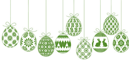 Green Easter eggs with intricate patterns hanging on ribbons, celebrating spring and holiday traditions.