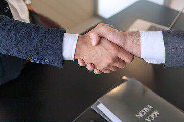 Business handshake with contract