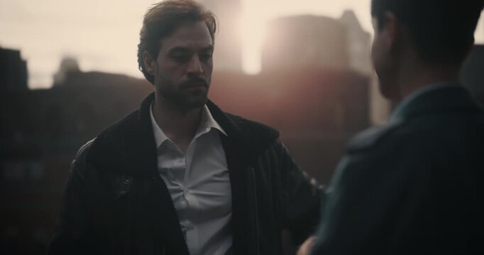 Two Male Gangsters Meet on a Rooftop for a Secret Bribe, Criminal Villain Suddenly Pulls a Gun. Cinematic Crime Footage Ideal for Mock‑up Screen Replacement, Action Movie or Trailer