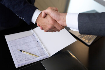 Business handshake with contract