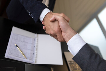 Business handshake with contract