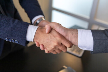 Business handshake with contract