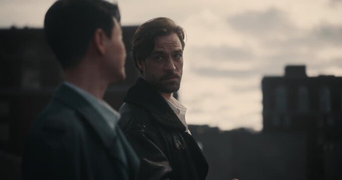 Two Male Gangsters Share a Silent Rooftop Standoff, Exchanging a Secret Documents and Lighting a Cigarette in Moody Cinematic Drama Clip. Fictional Crime Episode for Trailer, Movie, Film Concept