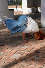 Young woman performing urban acrobatics street dance