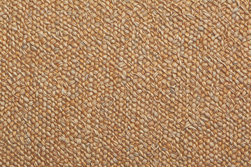 Close-up of woven natural fibers showcasing intricate texture and organic golden-brown tones.