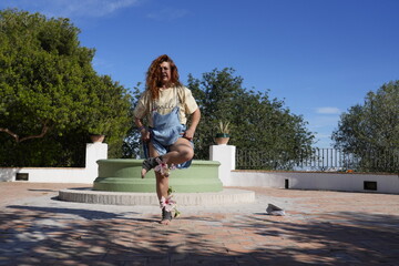 Woman practicing yoga outdoors with hibiscus flowers
