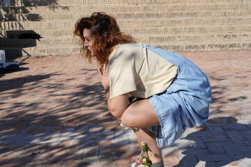 Woman practicing yoga outdoors with hibiscus flowers