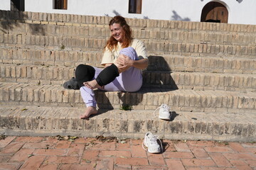 Woman preparing for exercise by putting on knee support