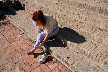 Woman preparing for exercise by putting on knee support