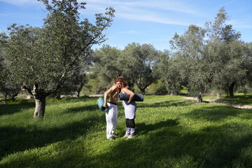 Couple preparing yoga mats for outdoor exercise
