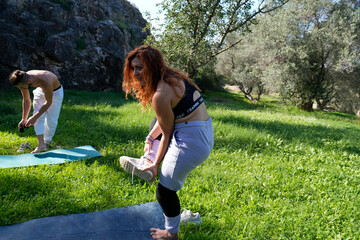 Couple preparing yoga mats for outdoor exercise