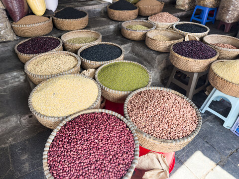 View of vibrant beans and grains bursting in woven baskets, a colorful mosaic of textures and hues in the bustling market stalls, Hanoi, Hanoi, Vietnam.