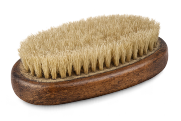 Oval wooden brush with bristles on transparent background, closeup.