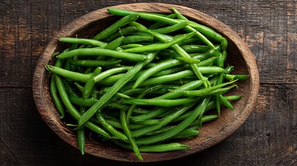 Green beans in a wooden plate on a white background, top view	