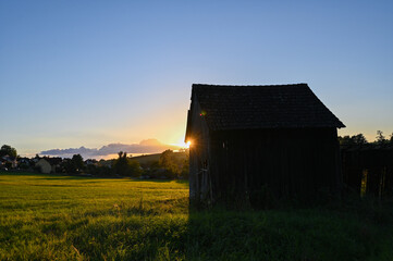 Part of an old barn in green nature and bright sunshine