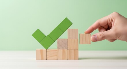 Hand placing wooden block on green check mark graph