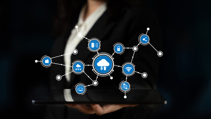Professional individual displaying a tablet with cloud technology and digital icons, symbolizing the future of connectivity and data management in business environments. Tessel