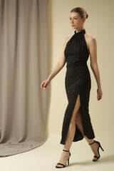 Statement black maxi open-back silk maxi dress with tie neck and thigh-high slit. Wedding guest, formal evening events or parties luxury gown.