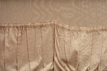 A horizontal close-up shot shows the gathered, elasticized top seam of the beige satin interior...