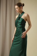 Ultra-glam statement maxi open-back silk maxi dress with tie neck and thigh-high slit. Wedding guest, formal evening events or summer parties emerald green luxury gown.