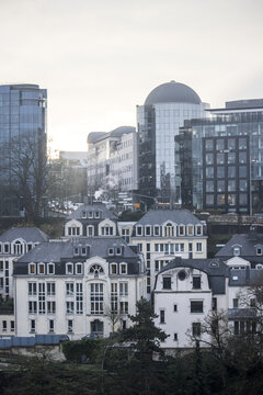 View of buildings blend with modern architecture under a soft, overcast sky, creating a serene yet contrasting cityscape, Luxembourg City, Luxembourg.