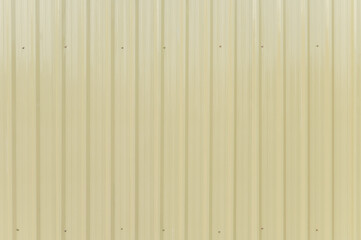 Pale yellow corrugated metal sheet background texture
