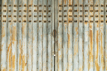 Vintage rusty folding door with star pattern cutouts