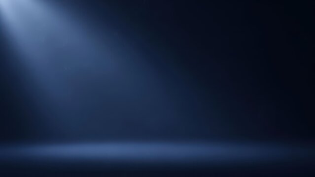 Empty dark blue studio stage illuminated by a single powerful spotlight beam from above, creating a dramatic and moody atmospheric background for product display.